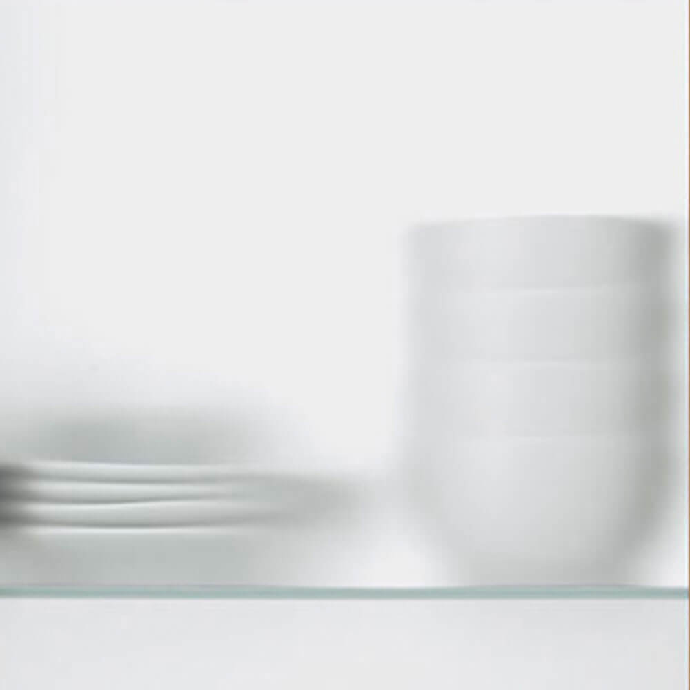 Clear glass cabinet doors showcasing modern kitchen design from Zen Living in Calgary.