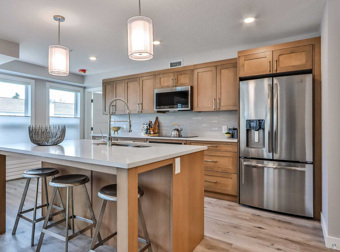 Modern multi-family kitchen with Zen Living cabinets and countertops in a stylish Calgary renovation.