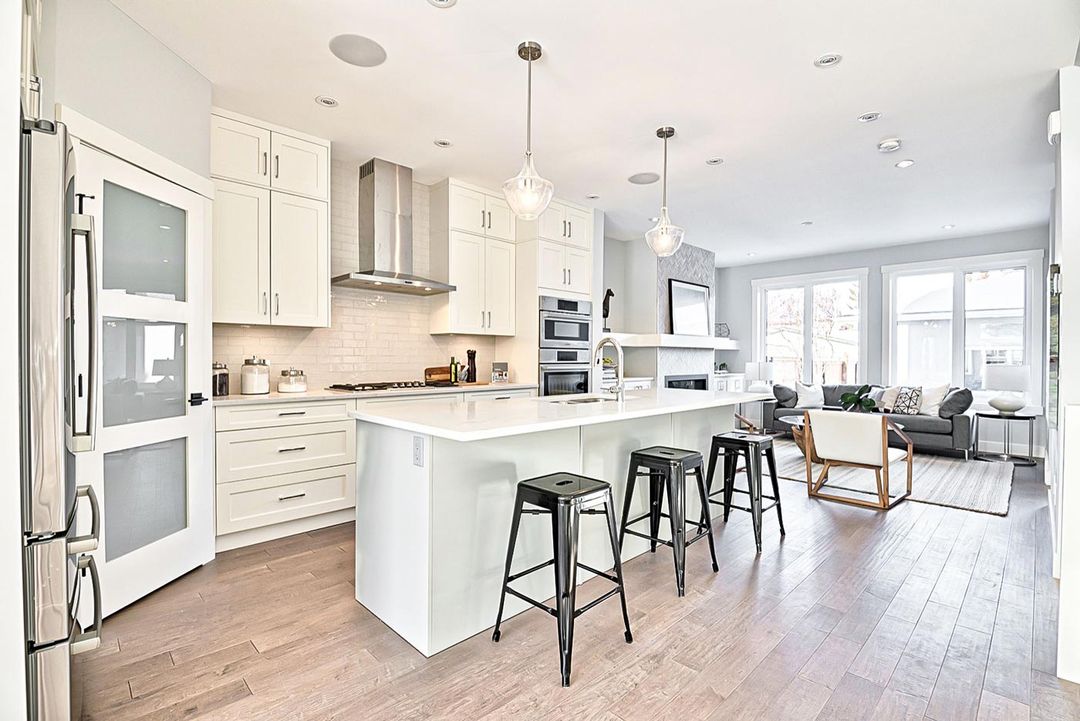 Modern basement development in Calgary featuring stylish kitchen cabinets and countertops by Zen Living.