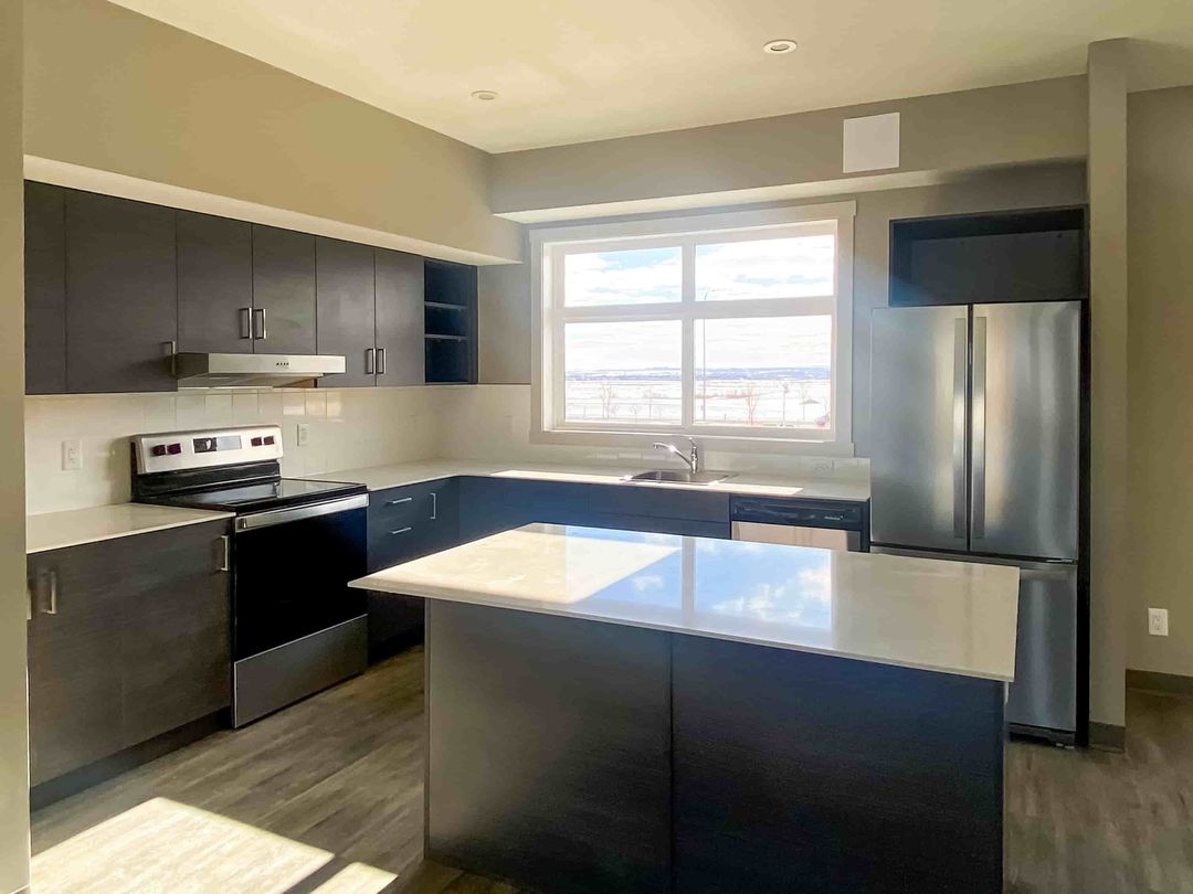 Stylish Calgary kitchen featuring Zen Living cabinets and countertops in a modern multi-family project setting.