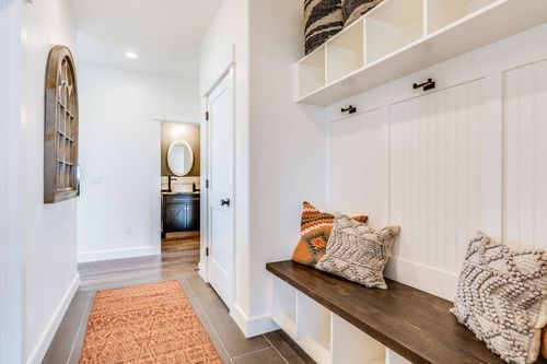 Cozy entryway with seating and decor.