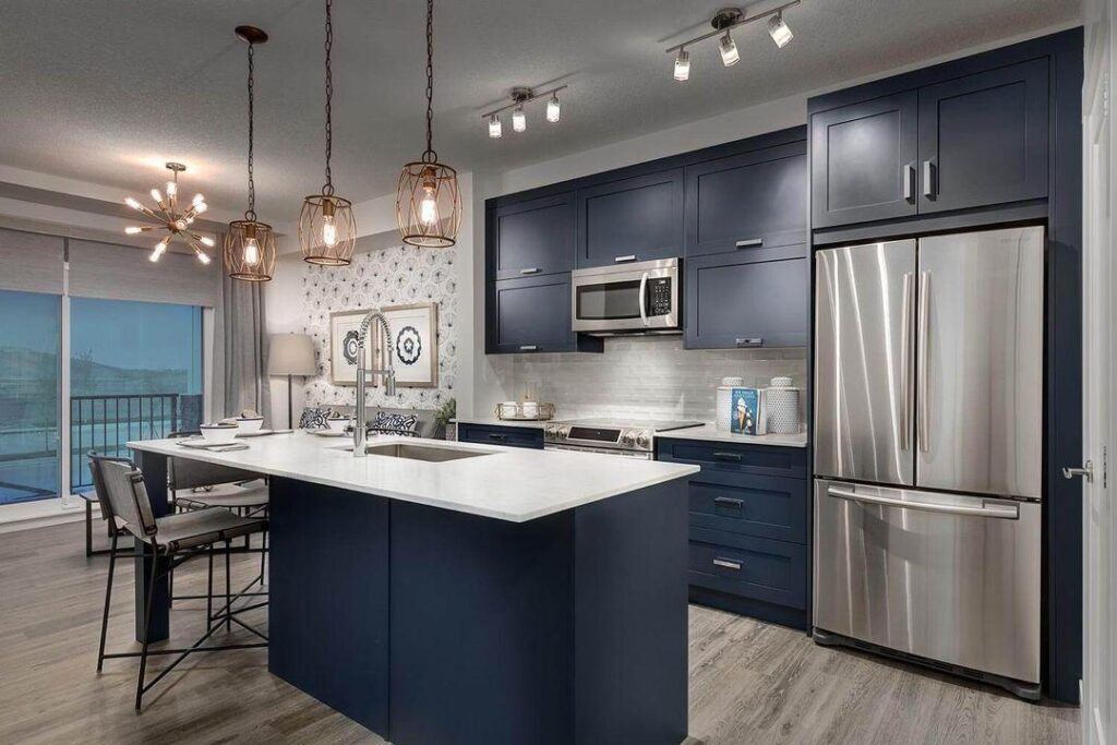 How to Choose Cabinet Hardware Color? 2 Sleek navy kitchen with modern appliances.