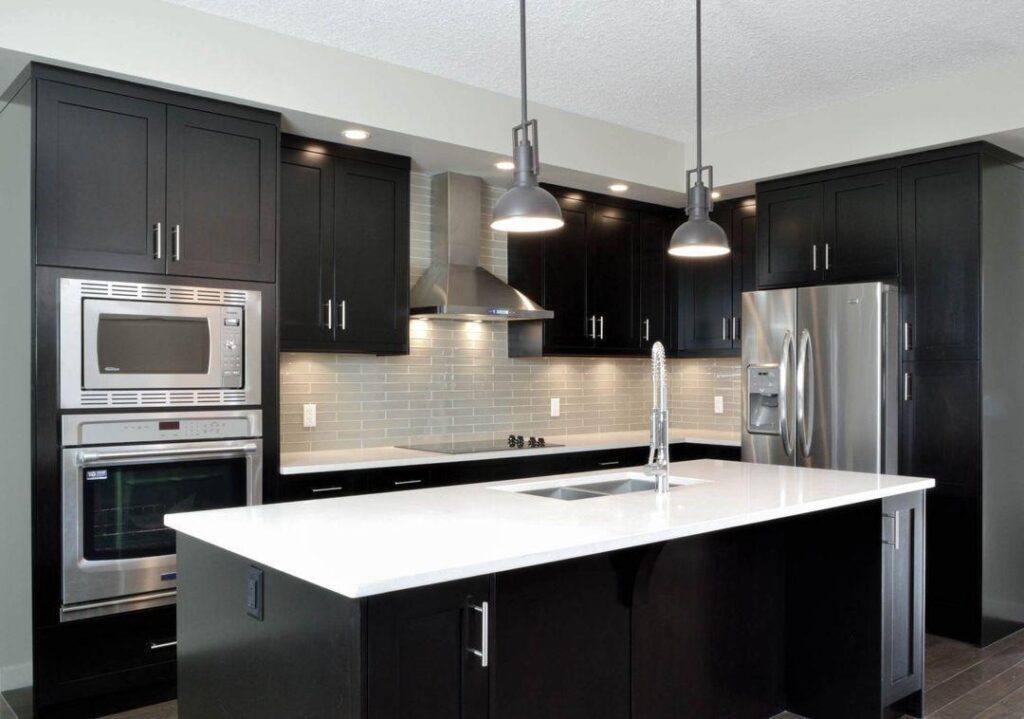 How a Kitchen Renovation Can Increase Your Home’s Value? 3 Sleek black kitchen with stainless appliances.