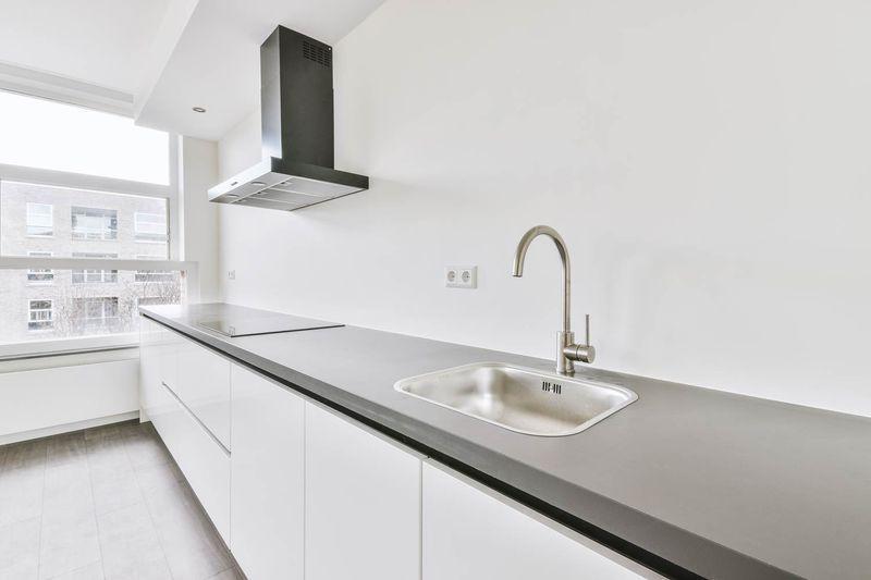 How to Finance a Kitchen Remodel: Smart Budgeting & Payment Planning 2 Minimalist kitchen with sleek design.