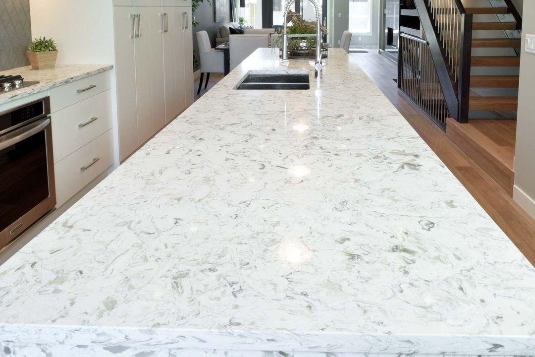 Modern kitchen island with a durable granite countertop, demonstrating the natural beauty that is a major pro of granite countertops.