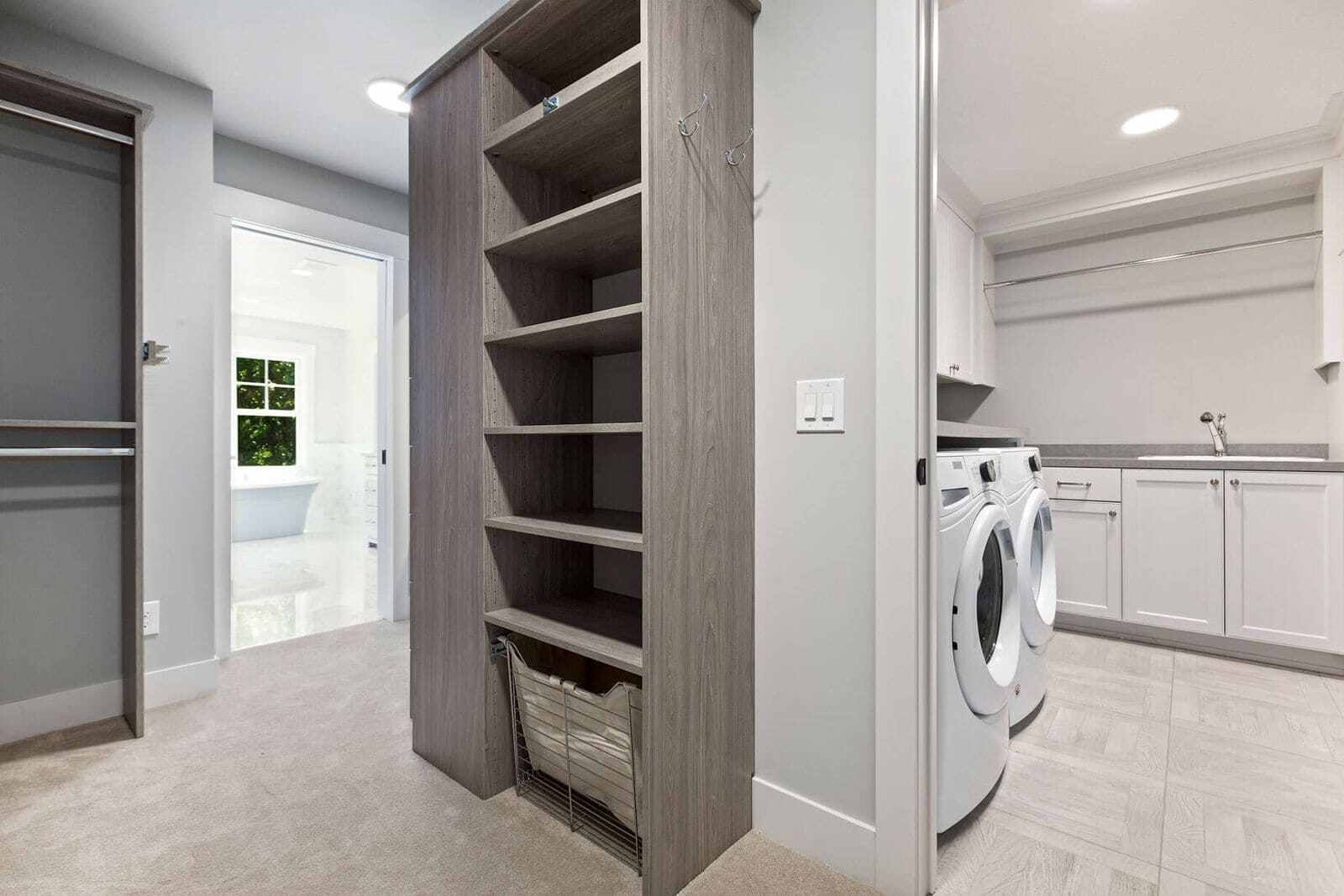 Built-in shelving and cabinetry in a bright laundry room, providing smart storage solutions to organize laundry room cabinets and keep essentials neatly arranged.