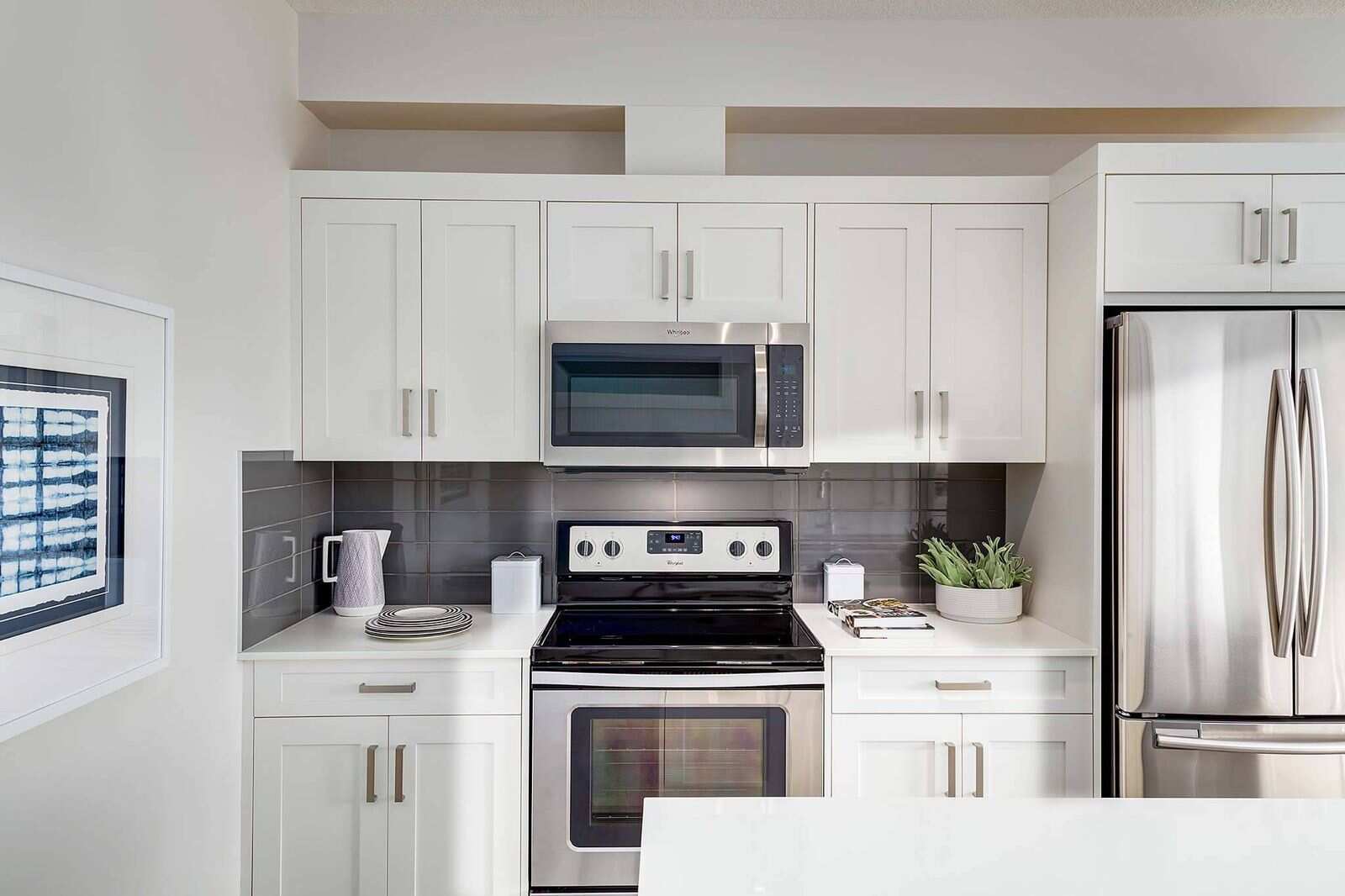 White kitchen cabinets with upper cabinet doors and glass-ready panels, illustrating choosing the right glass style for modern kitchen cabinetry design.