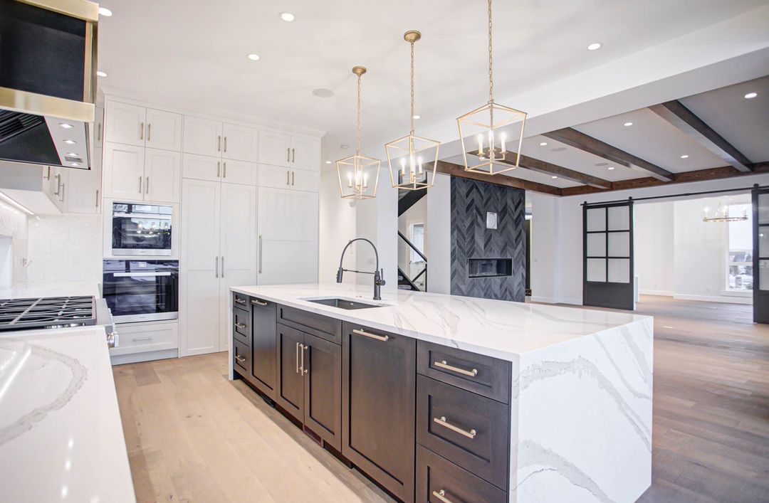 Spacious modern kitchen featuring white quartz countertops, highlighting how quartz performs exceptionally well indoors with durability, elegance, and low maintenance appeal.