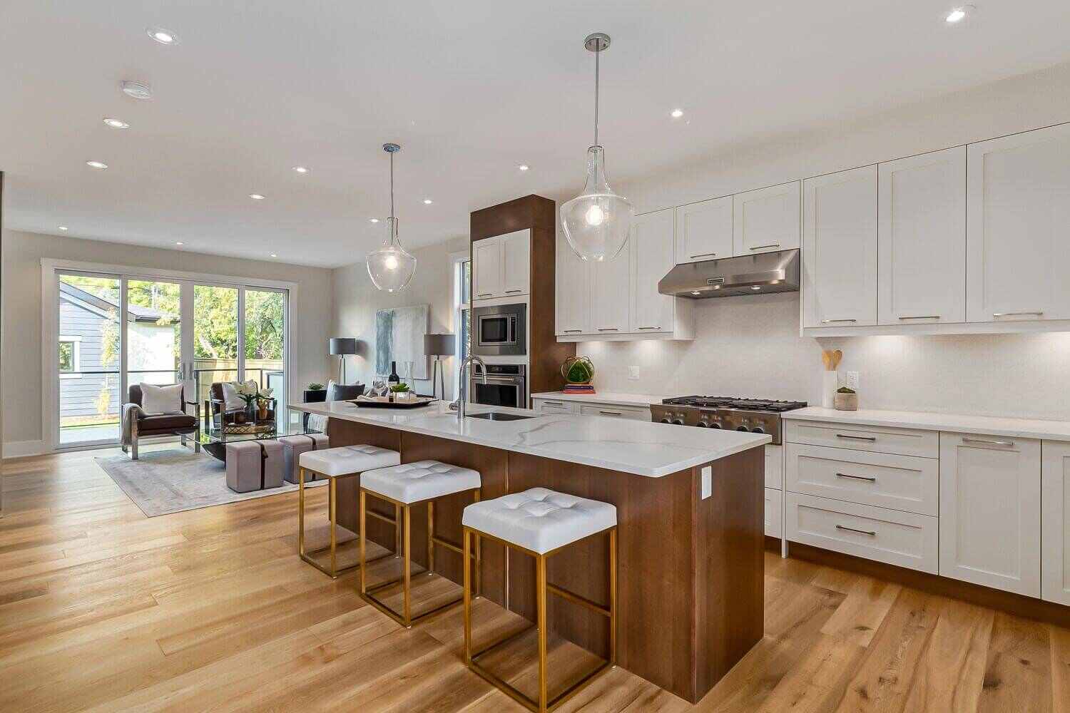 Modern kitchen with white upper cabinets where glass cabinets work best, placed along the main wall above the countertop to create visual openness and display space.