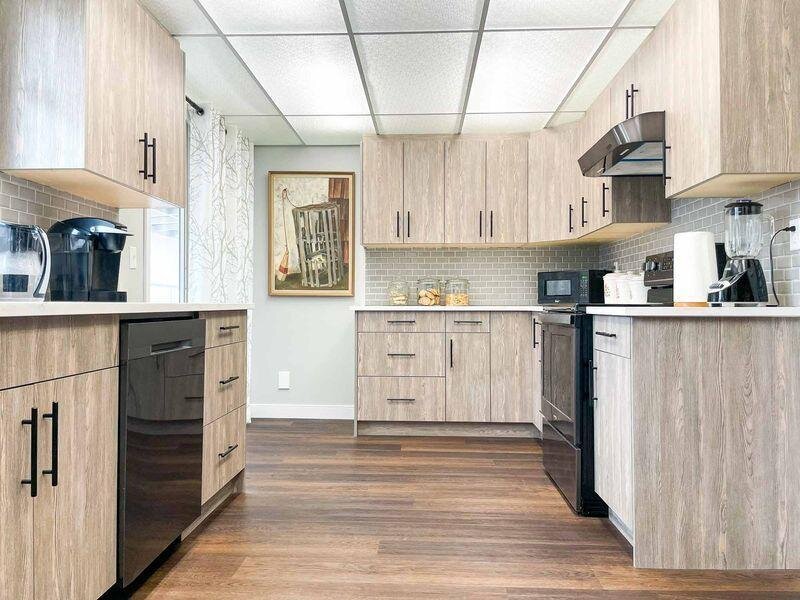 Kitchen designed for sizing flexibility and space efficiency with compact layout, light wood cabinetry, modern appliances, and optimized storage solutions.