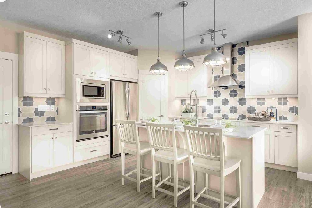Kitchen Reno Timeline: How Long Cabinets Actually Take (From Design to Install) 1 Bright modern kitchen with white cabinetry and island seating, illustrating the importance of cabinet timelines in coordinating a smooth kitchen renovation.