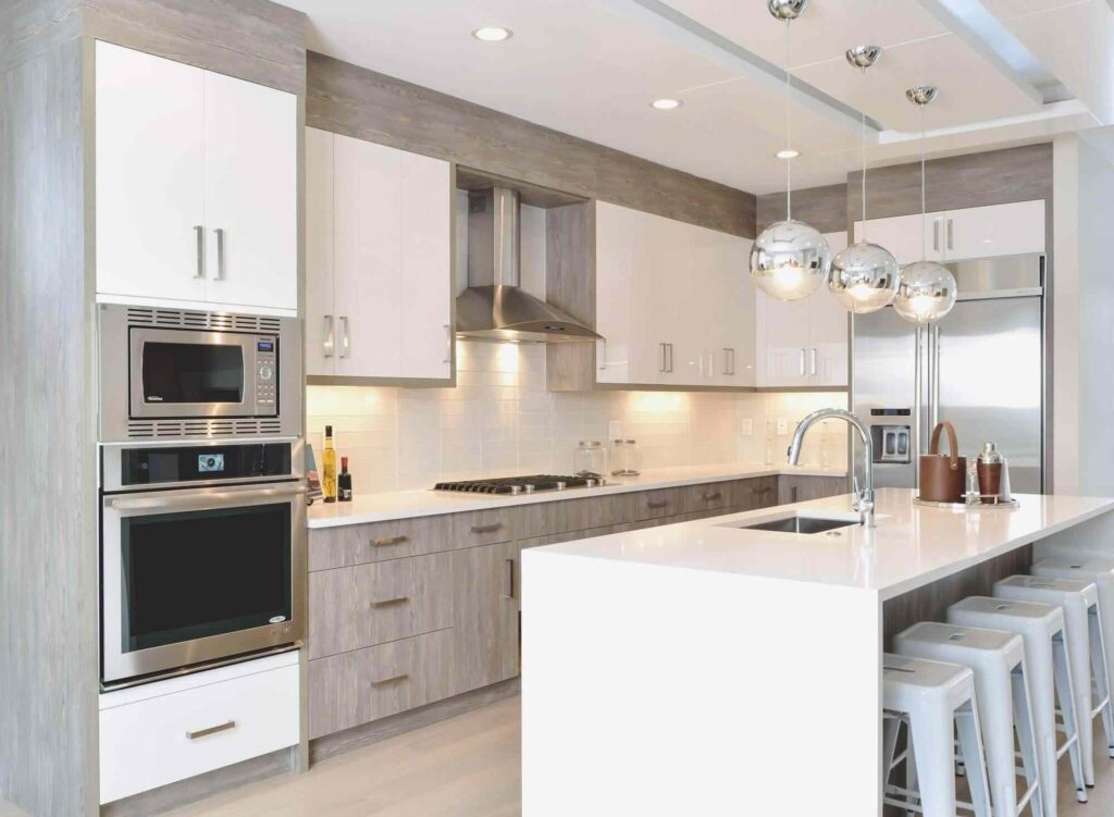 How Much Are Kitchen Renovations in 2026? 2 Modern kitchen featuring custom cabinetry with integrated hardware, soft-close drawers, stainless steel appliances, and polished finishing details.
