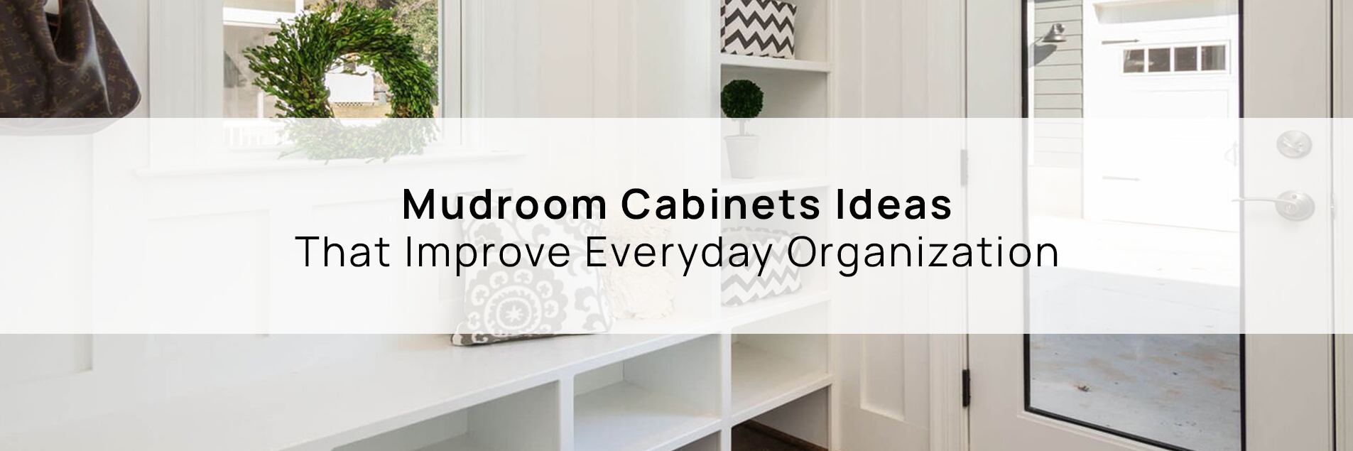 White mudroom cabinets with built-in bench, cubbies, and shelving near an entry door, showcasing practical mudroom cabinet ideas for everyday organization.
