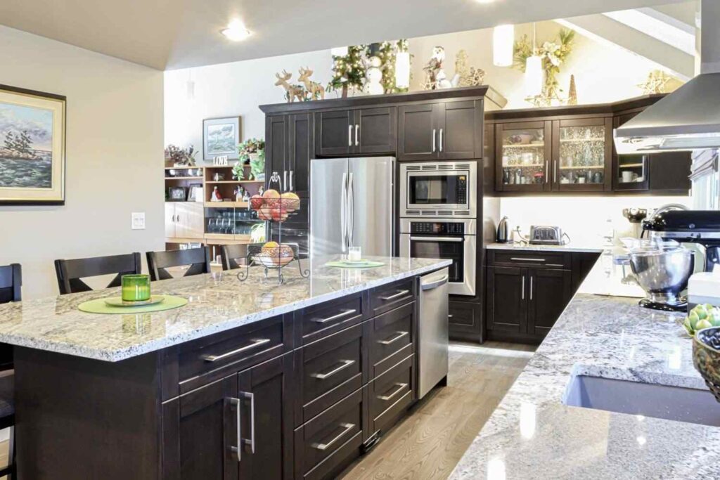 The Hidden Cost of Cabinet Delays for Contractors and How to Avoid Them 1 Custom wood cabinetry and large kitchen island, illustrating how a labour downturn can put pressure on cabinetry project costs.