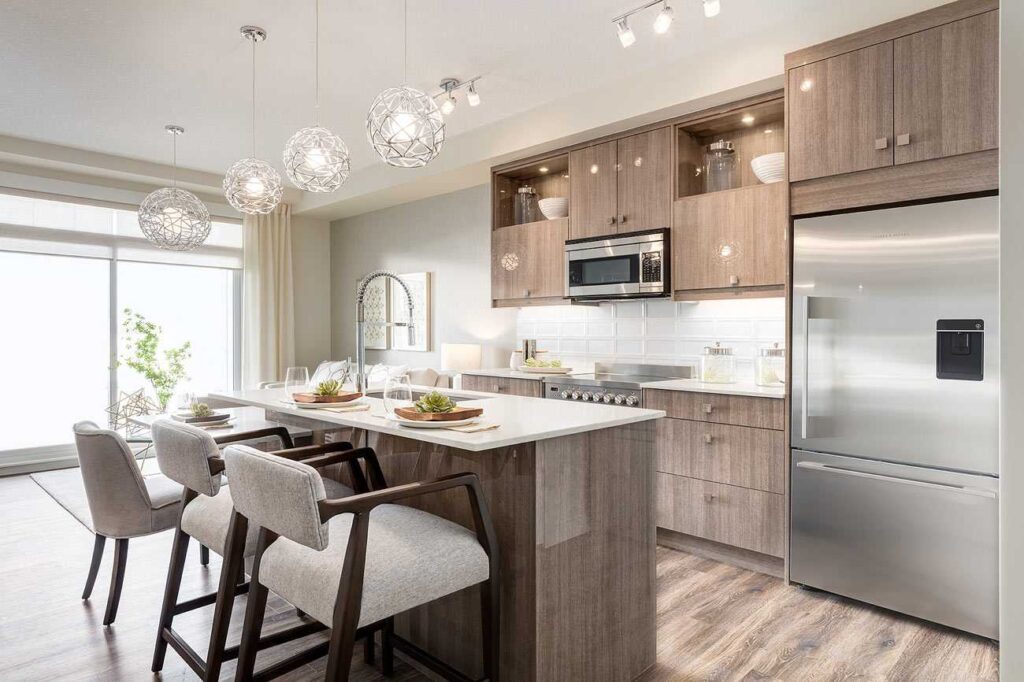 How Builders Can Standardize Cabinet Packages Across Multiple Homes 2 Modern kitchen with coordinated wood cabinetry and a large island, illustrating how builders can standardize cabinets while offering customization options.